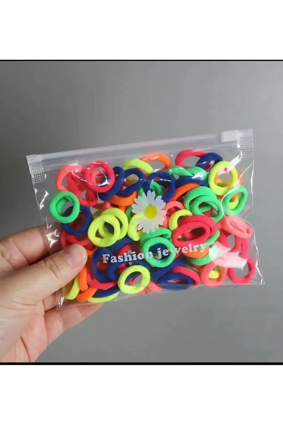 Şeffaf Çantalı 100'lü Lastik Toka Seti ile Şıklık ve Fonksiyonellik Bir Arada